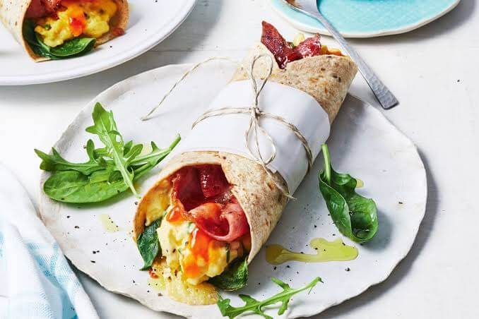 Brekky Burrito Our Wholegrain Brekky Burrito Wrap with Free Range Scrambled egg, Bacon, Spinach, Mozzarella & BBQ sauce. Protein 31g Carbohydrates 20g Fat 16g 348 Calories Heating instructions: remove lid and microwave for two minutes. We recommend our me